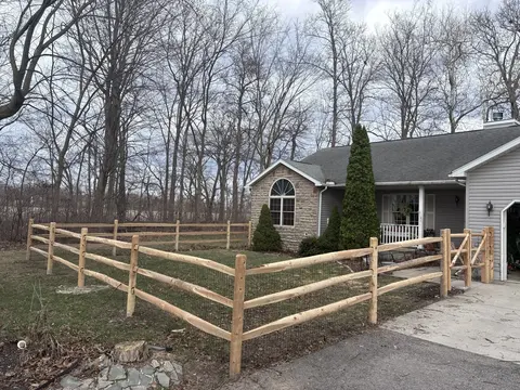 Wood rail fencing with wire mesh
