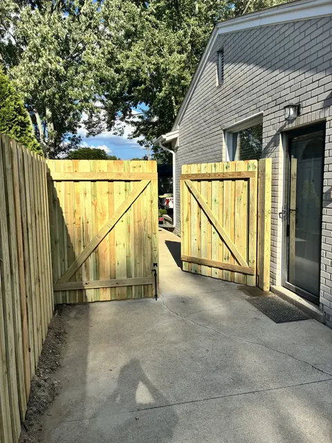 Pressure-treated double drive gate standing open