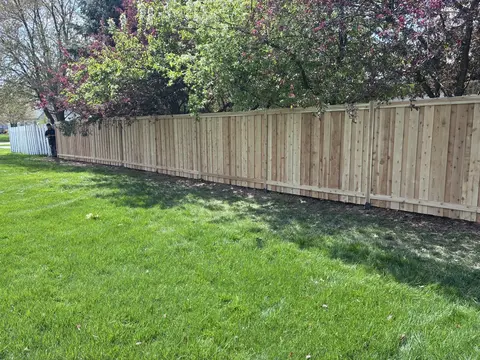 Wood privacy fence with a top cap