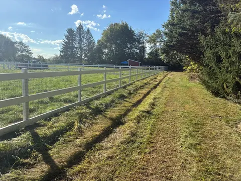 Wood rail fencing with wire mesh