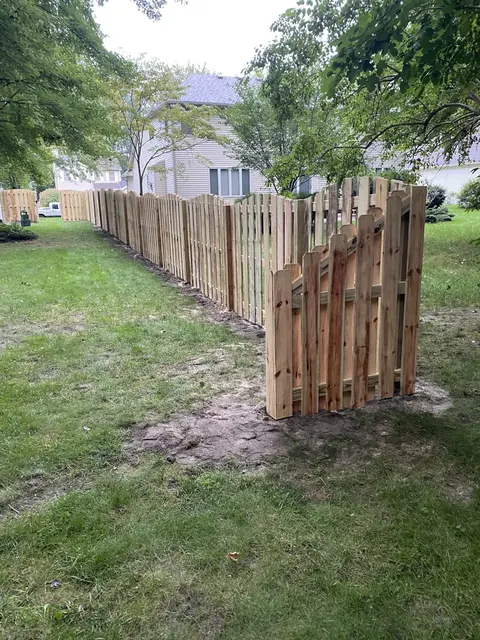 Wood fencing with a shaped top