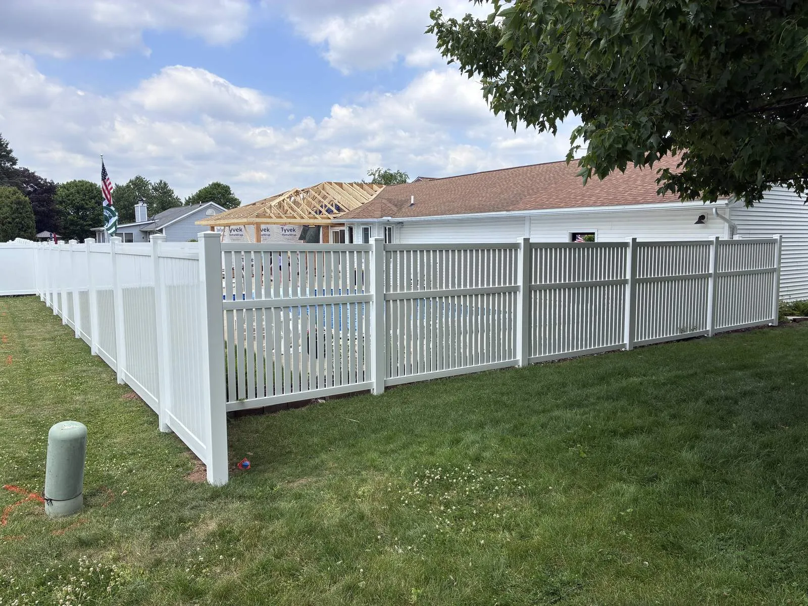 Vinyl privacy fence transitioning to spaced picket around a pool