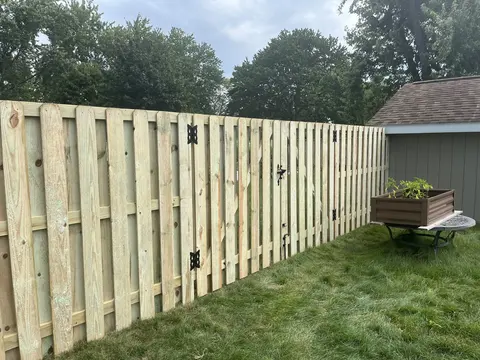 Pressure-treated shadowbox fence with walk gate