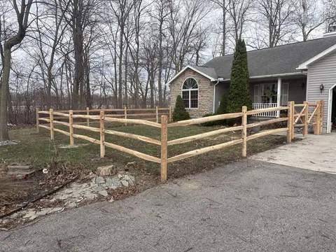 Wood rail fencing with wire mesh