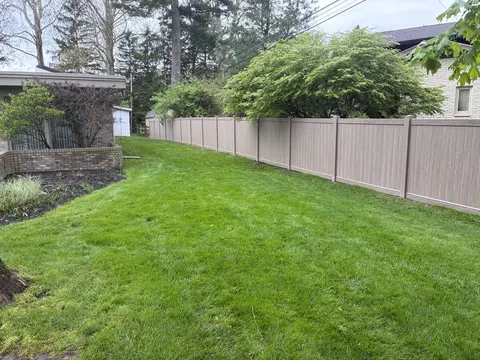 Woodgrain vinyl privacy fence.