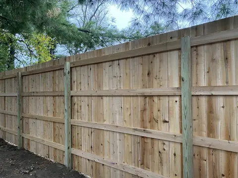 Wood fence rails attached to steel posts