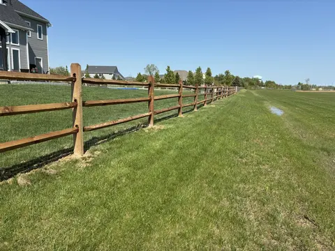 Wood rail fencing with wire mesh