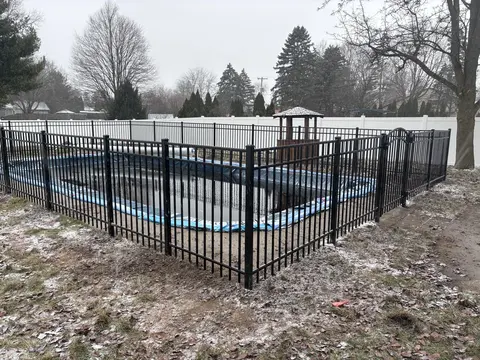 Ornamental metal fence with an arched gate