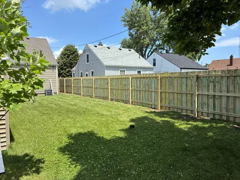 Long wood privacy fence viewed from the rails and posts side.