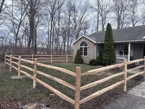 Wood rail fencing with wire mesh