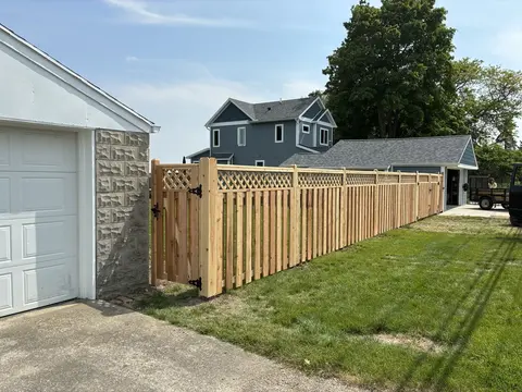 Wood privacy fence with lattice above the boards