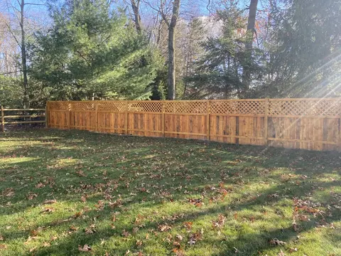 Wood privacy fence with lattice above the boards