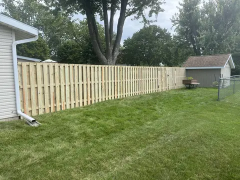 Shadowbox fence along the side of a house