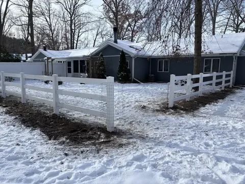Wood rail fencing with wire mesh