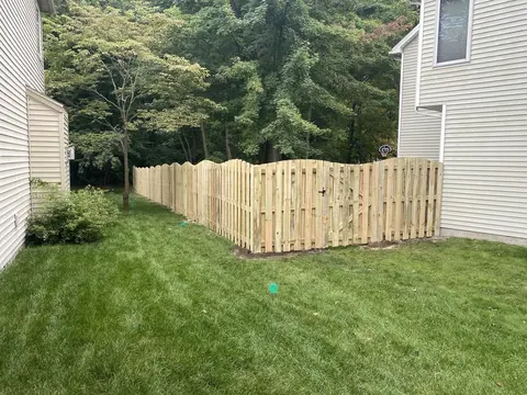 Wood fencing with a shaped top