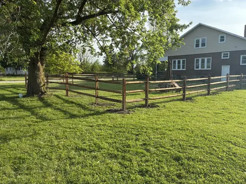 Wood rail fencing with wire mesh