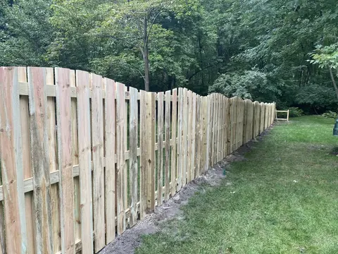Wood fencing with a shaped top
