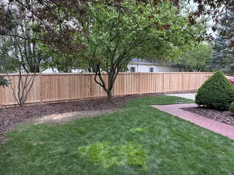 Wood privacy fence with a top cap