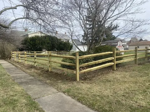 Wood rail fencing with wire mesh
