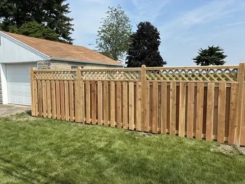 Wood privacy fence with lattice above the boards