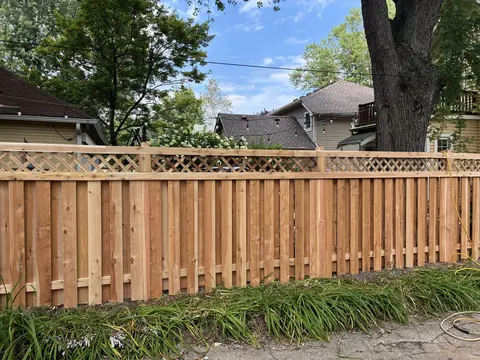 Wood privacy fence with lattice above the boards