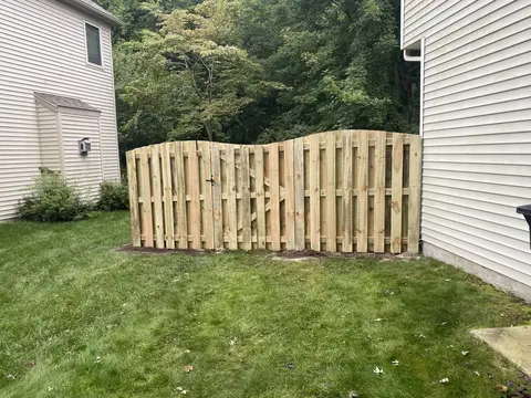 Wood fencing with a shaped top