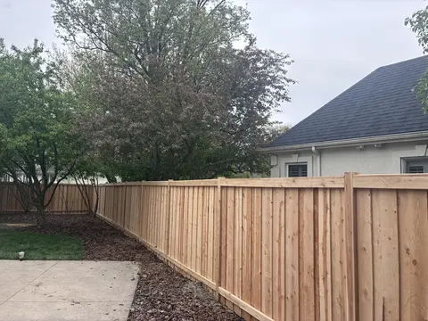Wood privacy fence with a top cap