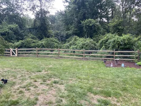 Wood rail fencing with wire mesh
