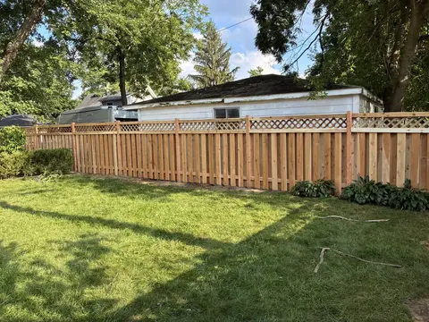 Wood privacy fence with lattice above the boards