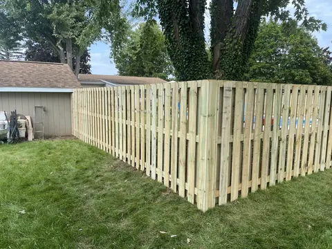 Alternating pickets on both sides of the rails create a shadowbox layout.
