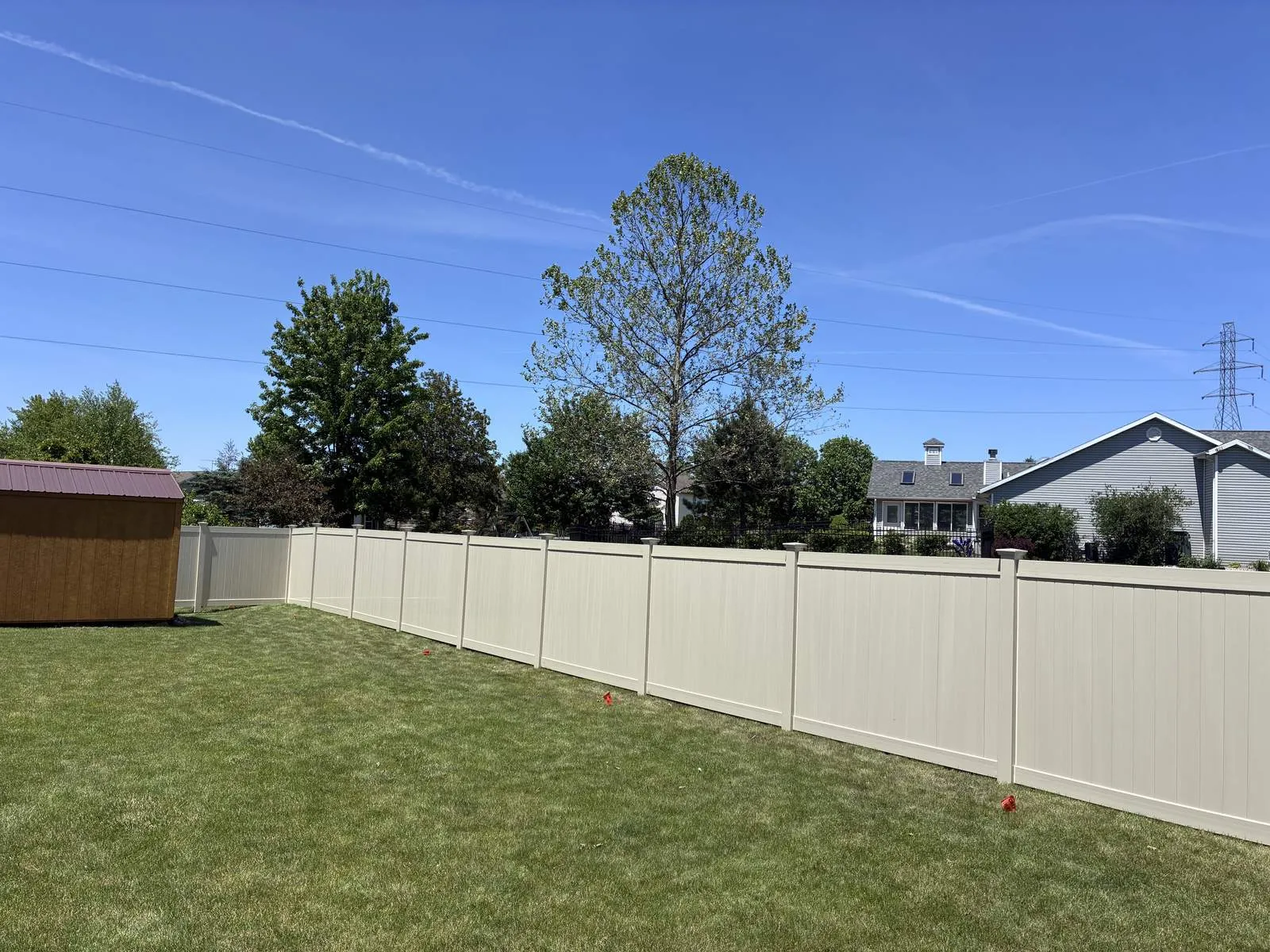 Tan vinyl privacy fence.