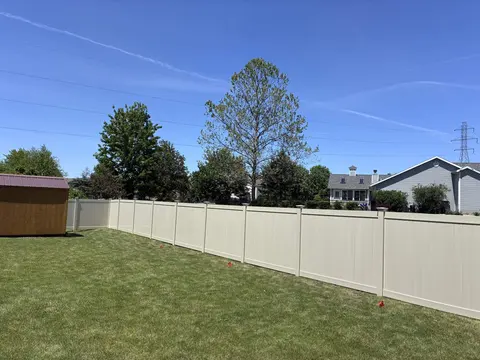 Tan vinyl privacy fence