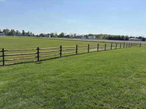 Wood rail fencing with wire mesh
