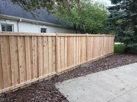 Wood privacy fence with a top cap