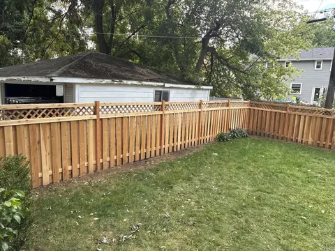 Wood privacy fence with lattice above the boards