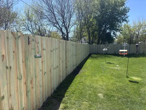 Overlapping vertical boards form this board-on-board privacy fence.