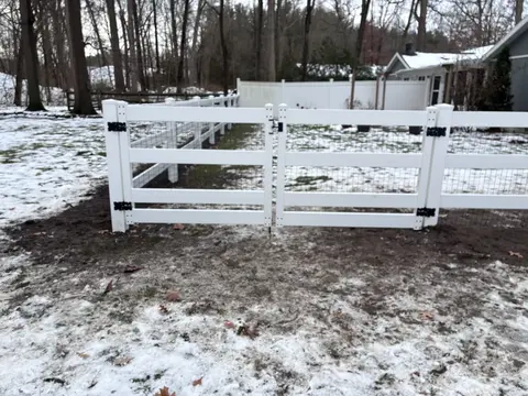 Wood rail fencing with wire mesh