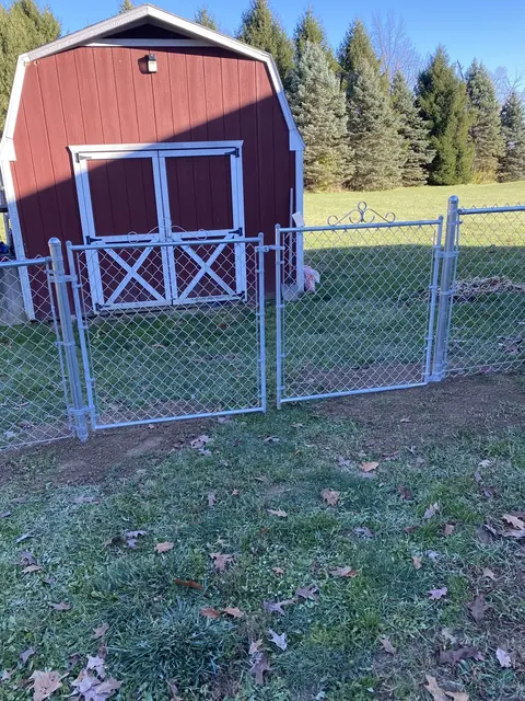 Decorative scrolls finish the top of these chain-link gate frames.