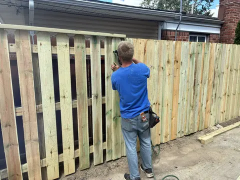 Wood pickets being fitted to the fence rails.