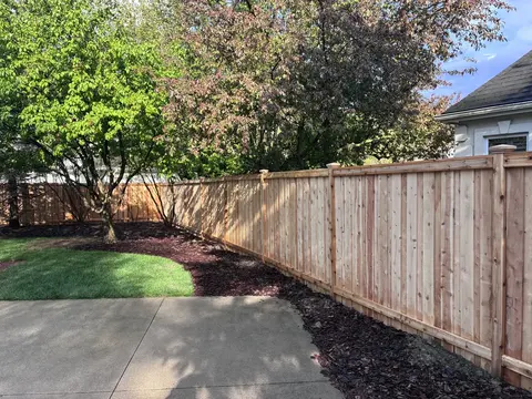 Wood privacy fence with a top cap