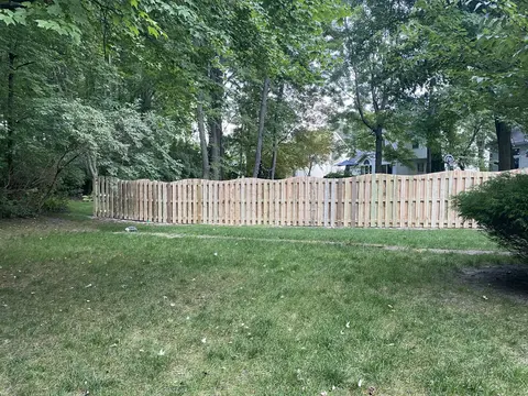 Wood fencing with a shaped top