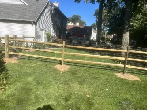 Wood rail fencing with wire mesh