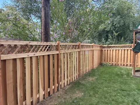 Wood privacy fence with lattice above the boards