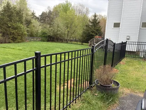 Ornamental metal fence with an arched gate
